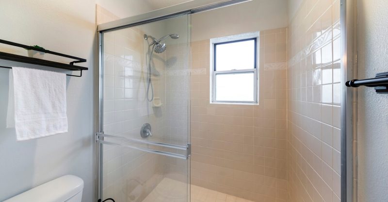 how to clean between sliding shower doors